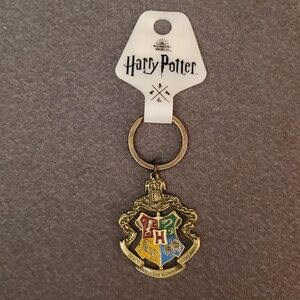 NWT Harry Potter metallic pivotal keychain. Four houses. From NYC store.